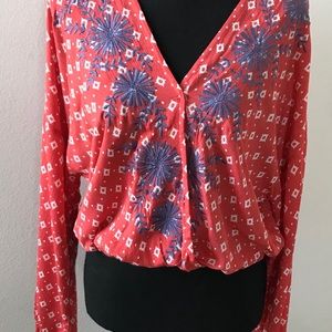 juniors Boho top. Blue embroidery on orange print.